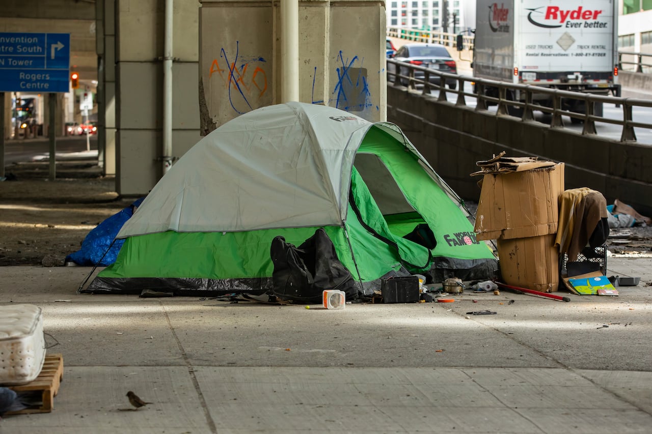 A homeless person's tent under the Gardiner Expressway at Lake Shore Boulevard West and York Street on March 24, 2023.. See tent, fly and belongings under the road beside the on-ramp. Recent city data shows Toronto saw an average of more than three d