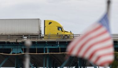A transport truck crosses the Ambassador Bridge into the United States, in Windsor, Ont., Saturday, Aug. 22, 2026. THE CANADIAN PRESS/Dax Melmer