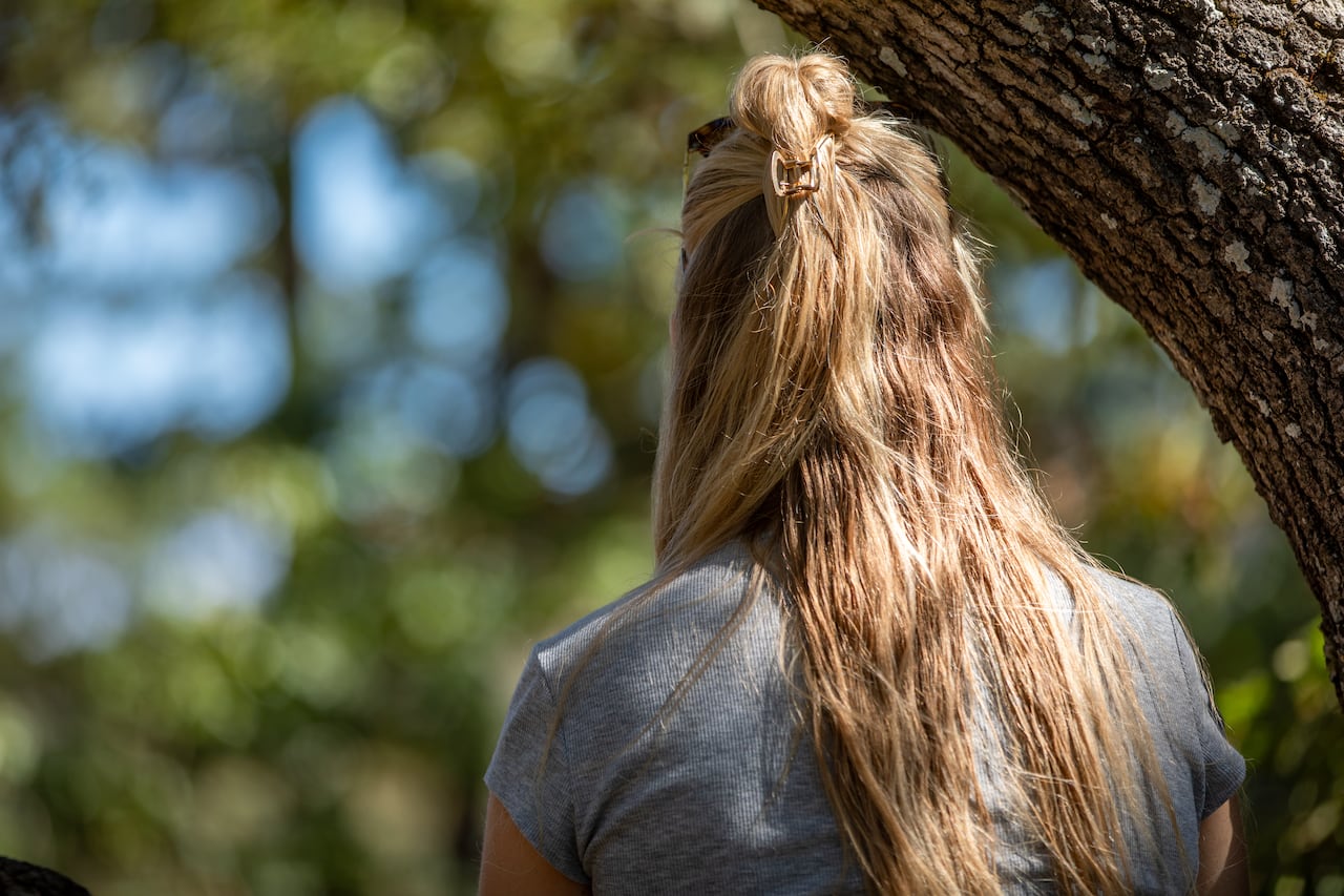 a woman sits in a park