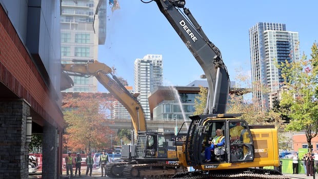 Surrey mayor first to tear into building, starting demolition for new 10,000-seat arena