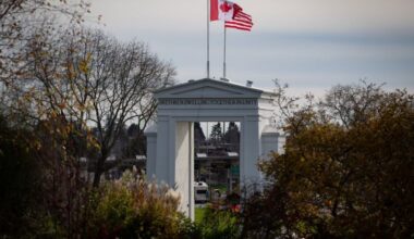 Canadian and U.S. flags fly atop the Peace Arch monument at the Douglas-Peace Arch border crossing in Surrey, B.C., Monday, Nov. 8, 2021. THE CANADIAN PRESS/Darryl Dyck