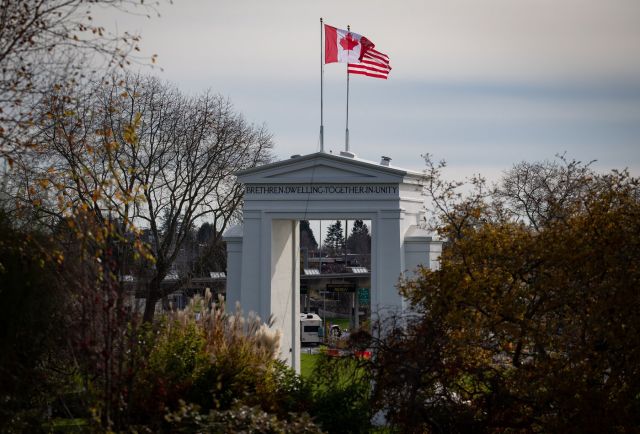 Canadian and U.S. flags fly atop the Peace Arch monument at the Douglas-Peace Arch border crossing in Surrey, B.C., Monday, Nov. 8, 2021. THE CANADIAN PRESS/Darryl Dyck