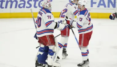New York Rangers goaltender Louis Domingue (70) and left wing Alexis Lafrenire (13) celebrate their win against the Chicago Blackhawks at United Center.