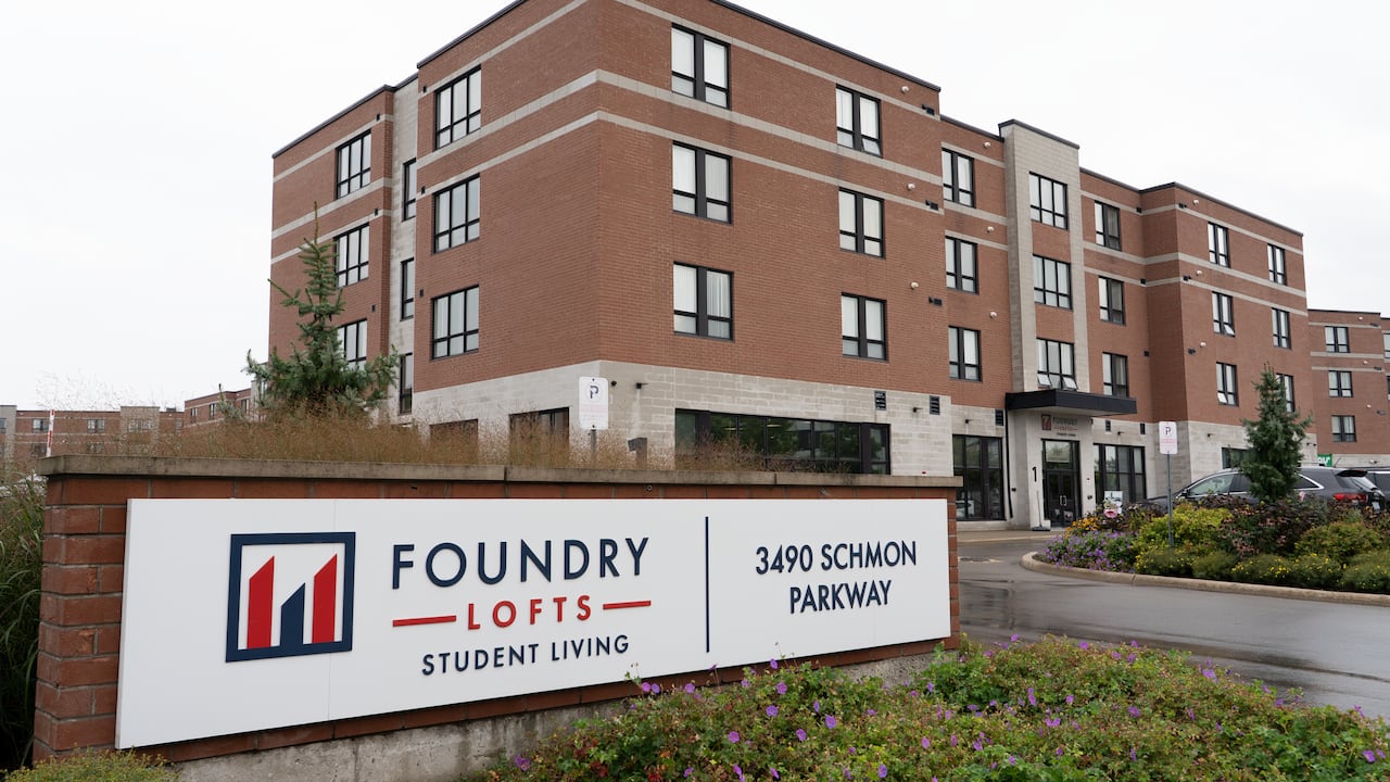 building on a cloudy day with sign in front with words Foundry Lofts Student Living