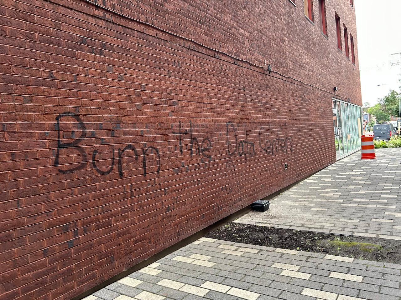 The phrase Burn the Data Centers is spray painted on a brick wall