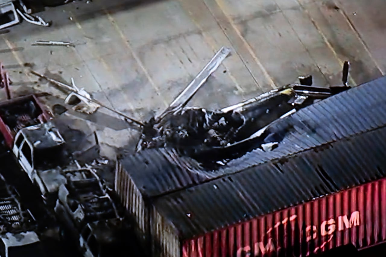 In this aerial photo, a helicopter is shown crumpled on the ground, its propeller smashed into a building.