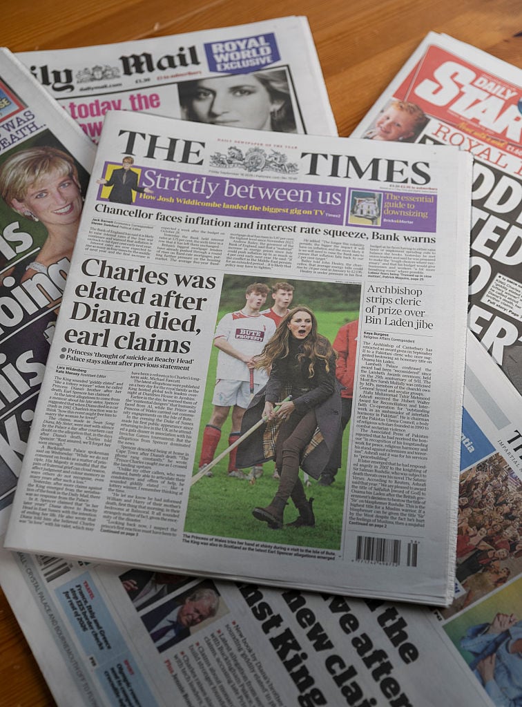 A collection of newspapers are displayed.