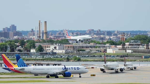 Some flights resume after ground stops at major U.S. airports, including New York's JFK and ‌LaGuardia