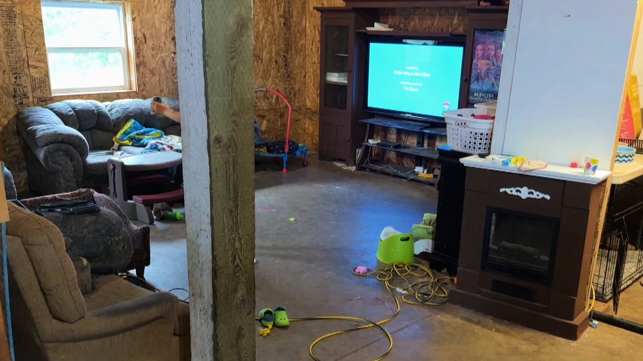 Part of a garage where a large screen television is shown.