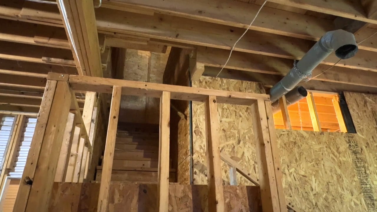 A staircase leading up to the second floor of a garage is shown.