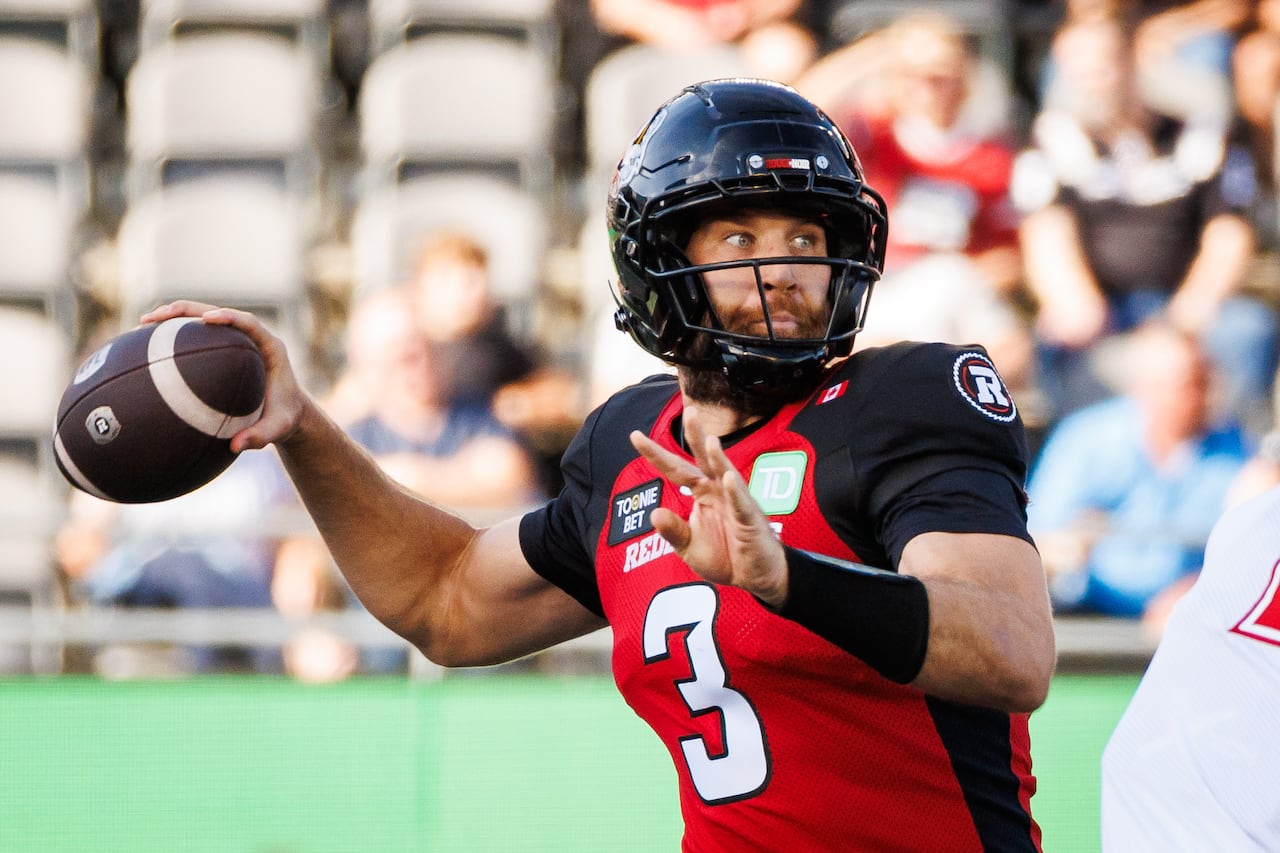 A football quarterback throws a ball.