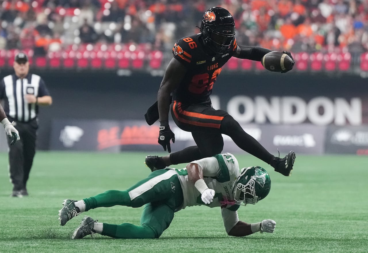 A man lies on the ground as another man jumps over him.