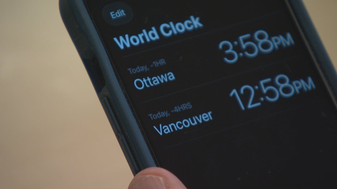 A time app is seen on a phone.