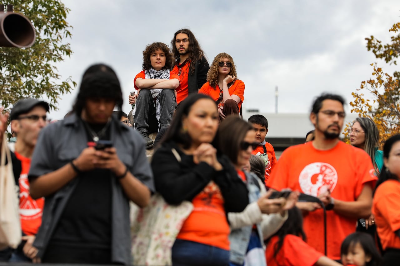 People wearing orange gather together.