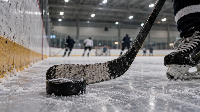 Illustration for Brampton Steelheads coverage: a hockey puck, stick and skate on rink ice.