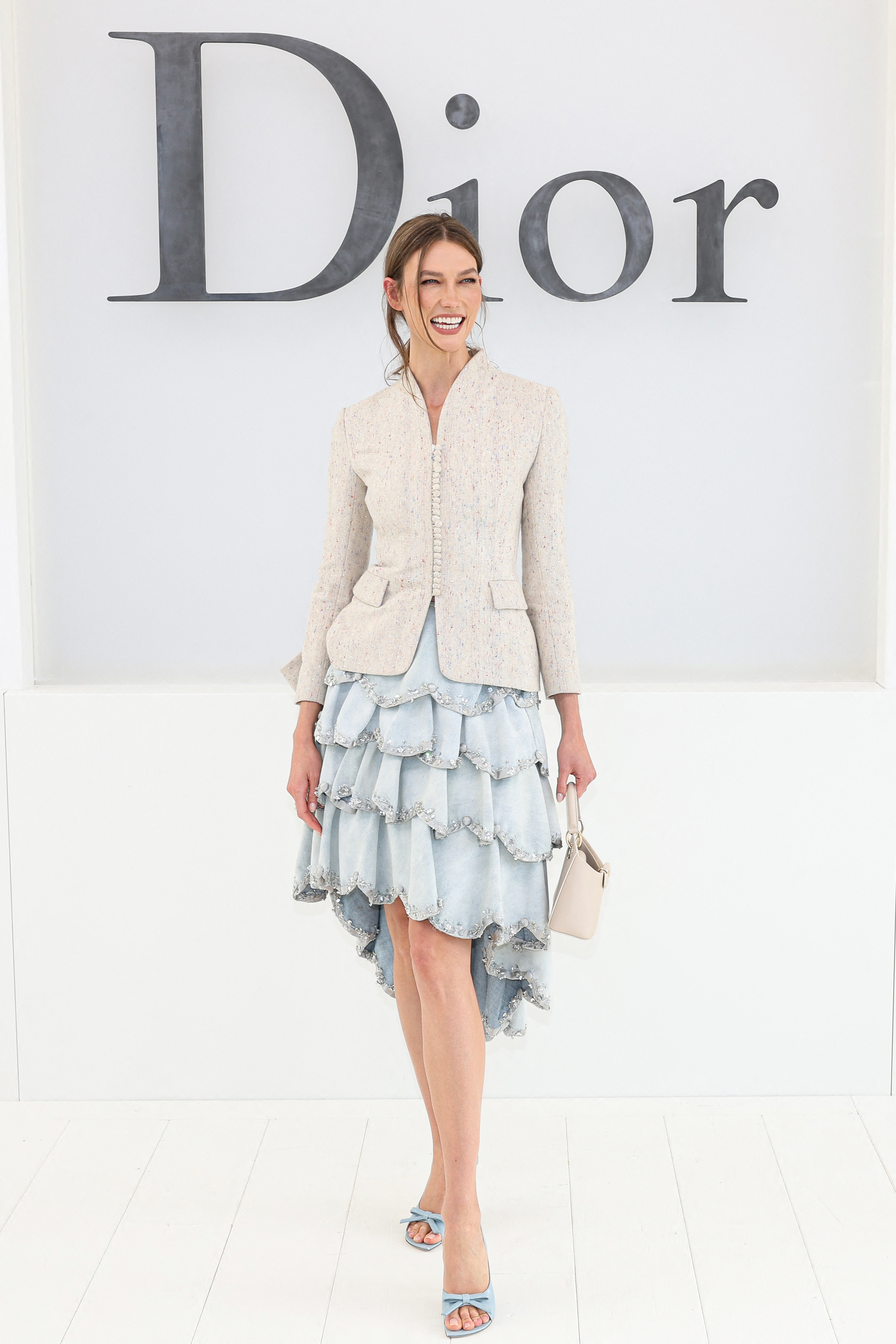 Karlie Kloss posing at a photocall before the Christian Dior Women's Spring/Summer 2027 fashion show.