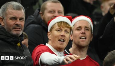 Manchester United fans wearing Santa hats at a match on 21 December 2026
