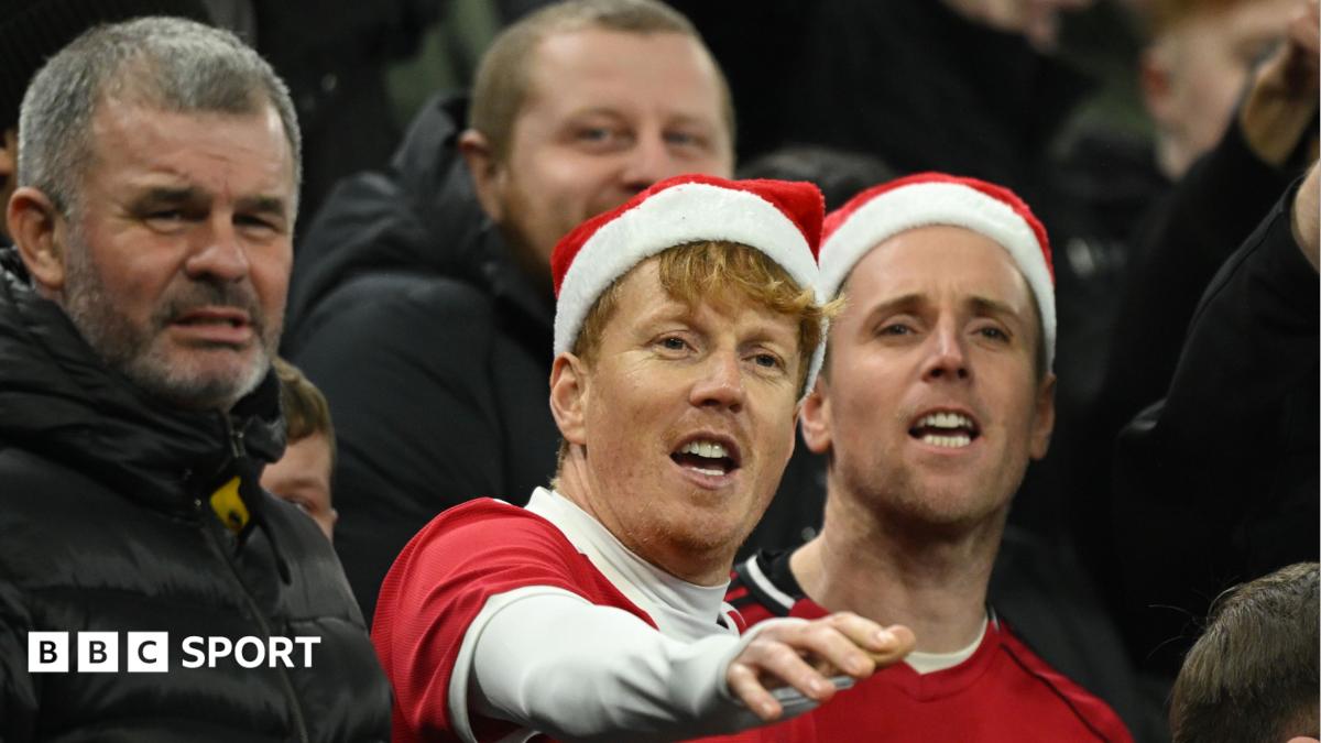 Manchester United fans wearing Santa hats at a match on 21 December 2026