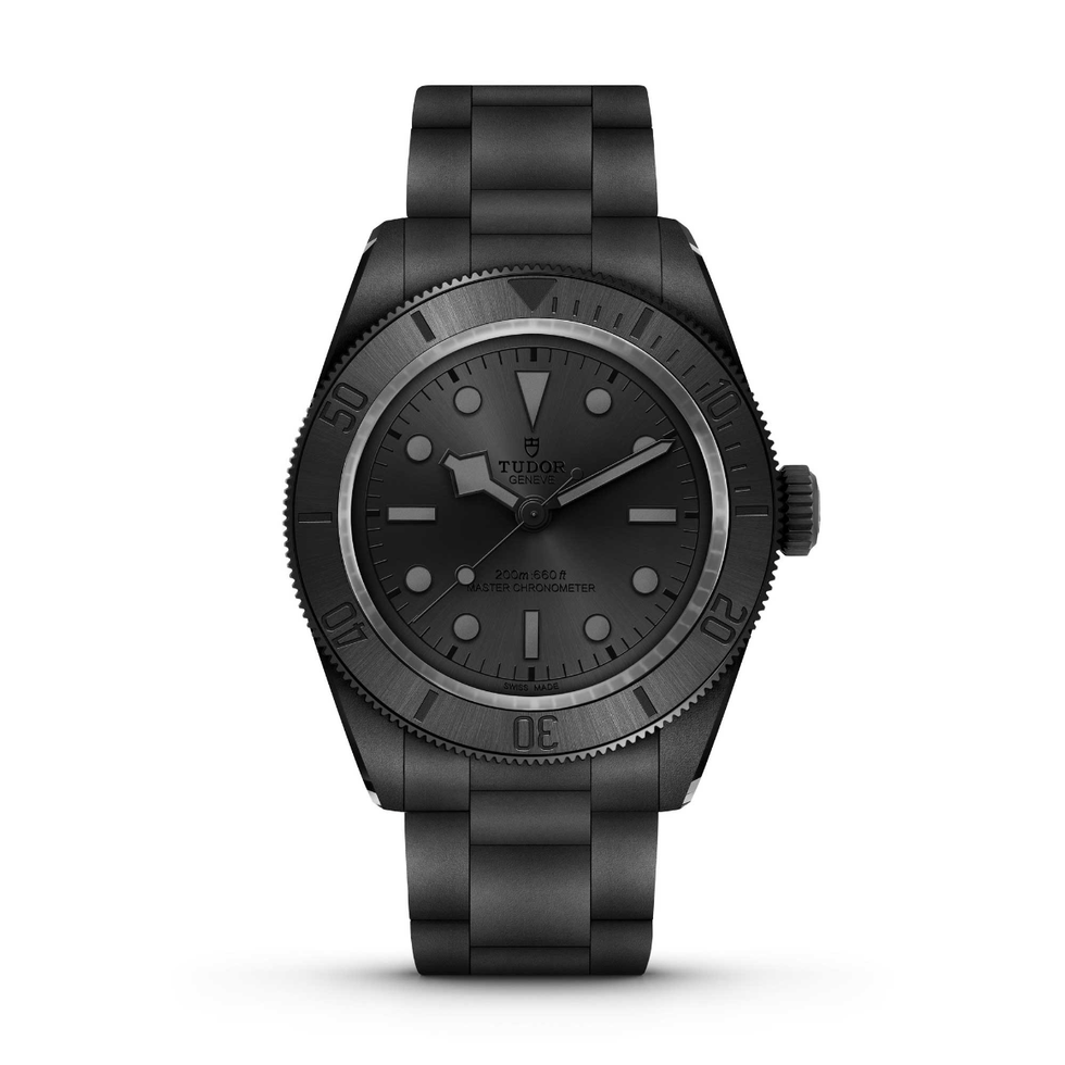 black tudor dive watch with a matte finish and metal bracelet.