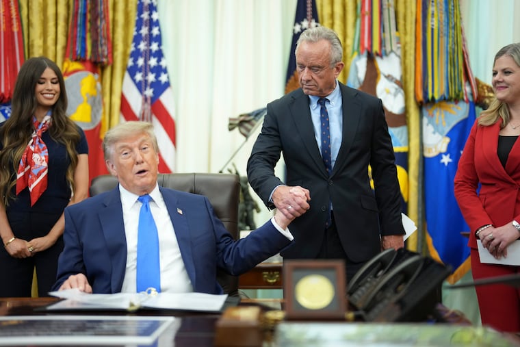 President Donald Trump and Health and Human Services Secretary Robert F. Kennedy Jr. at the signing of an executive order changing the guidelines for childhood vaccines on Aug. 10. The Trump administration has had a horrific impact on national health policy, write the authors.