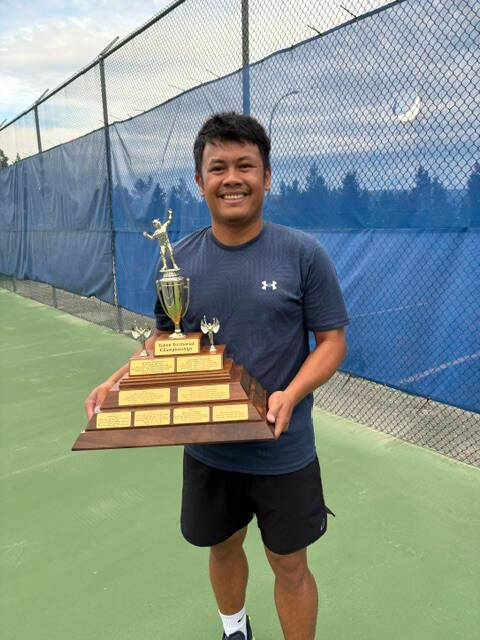 Ramzie Manongsong holds the men’s singles trophy after winning the 2026 Yukon Tennis Championships on Aug. 28. (Stacy Lewis/Submitted)