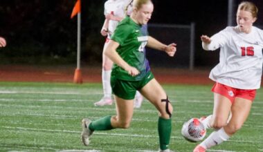 Edmonds-Woodway junior Audrey Rothmier (left) fights for a 50/50 ball against Silas sophomore Allison Conn during the Warriors 1-0 overtime loss to the Rams in the 3A Girls State Soccer Play-in Round at Edmonds Stadium on Nov. 12, 2025. (Joe Pohoryles / The Herald)