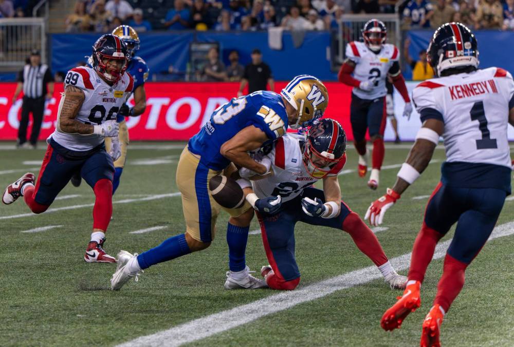 ROBERT LEE / FREE PRESS
Montreal Alouettes defensive back Nate Beauchemin hits Winnipeg Blue Bombers wide receiver Tommy Nield at the goal line to force a fumble on Friday.
