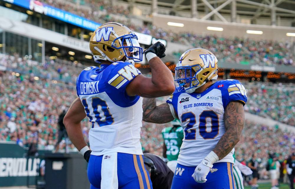 Heywood Yu / THE CANADIAN PRESS FILES
Winnipeg Blue Bombers receiver Nic Demski (left) celebrates his touchdown with running back Brady Oliveira during last season’s Labour Day Classic in Regina. The Bombers hope to play well enough to keep the Saskatchewan crowd from getting fired up.