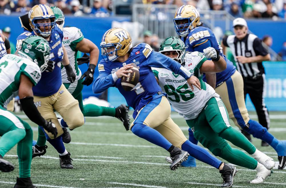 JOHN WOODS / THE CANADIAN PRESS
Winnipeg Blue Bombers quarterback Dru Brown (4) runs for the first down against the Saskatchewan Roughriders during second half CFL action in Winnipeg on Saturday.