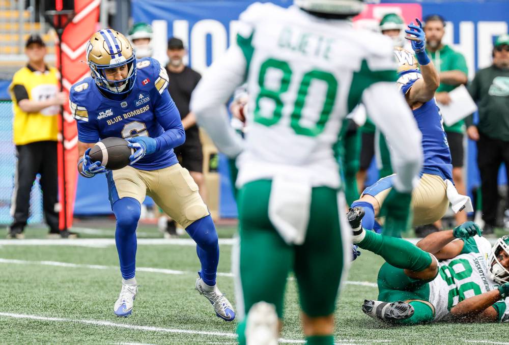 JOHN WOODS / THE CANADIAN PRESS
Winnipeg Blue Bombers’ Redha Kramdi (6) intercepts the pass as it bounces off Saskatchewan Roughriders’ Johnny Johnson (88) during second half CFL action in Winnipeg on Saturday.