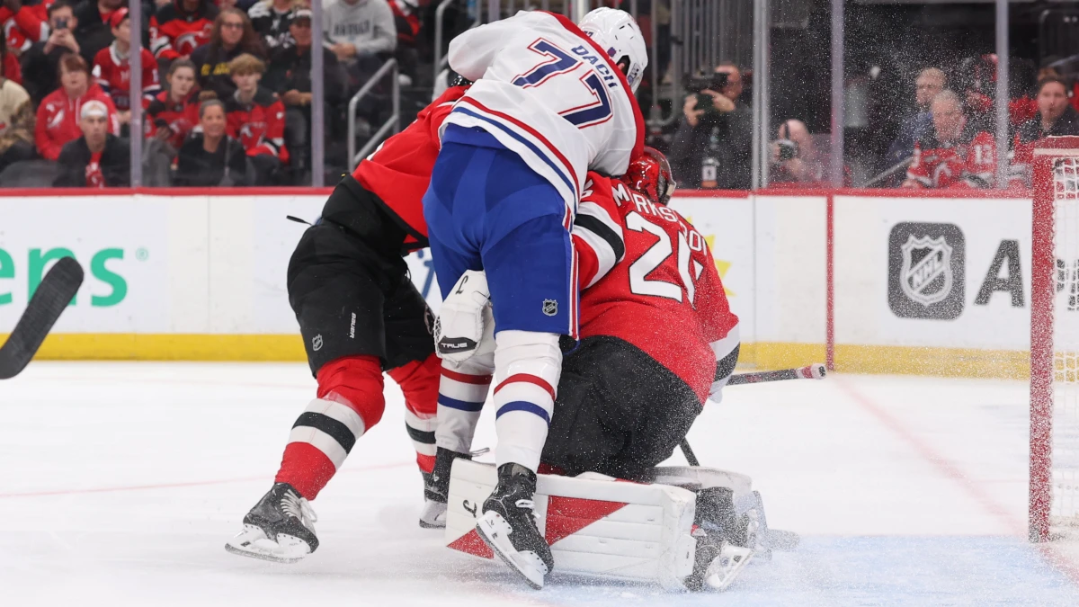 Montreal Canadiens center Kirby Dach (77) collides with New Jersey Devils goaltender Jacob Markstrom (25) during the first period at Prudential Center.