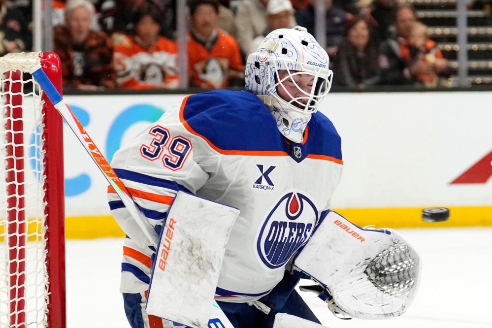 Edmonton Oilers goaltender Connor Ingram deflects a shot during the first period of Game 3 in the first round of the NHL hockey Stanley Cup playoffs series against the Anaheim Ducks, Friday, April 24, 2026, in Anaheim, Calif. (AP Photo/Mark J. Terrill)