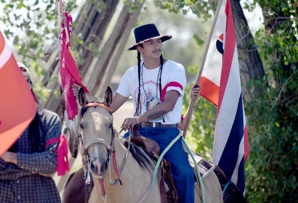 Kolten Lawrence protests near the Foundations for Nations church in Arapahoe, Wyo., on Sunday, Aug. 16, 2026. (AP Photo/Thomas Peipert)