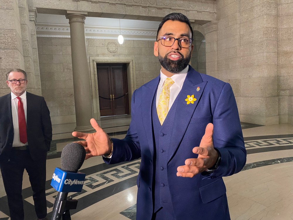 Obby Khan speaks to reporters after being sworn-in as a member of the Manitoba legislature in Winnipeg, Monday, April 4, 2022. Khan won a byelection in the Fort Whyte constituency in Winnipeg on March 22. THE CANADIAN PRESS/Steve Lambert