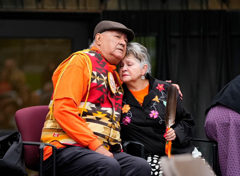 Elder Claudette Commanda embraces residential school survivor Eugene Arcand after his remarks during the Survivor's Flag ceremony on Parliament Hill in Ottawa on Wednesday, Sept. 30, 2026. THE CANADIAN PRESS/Justin Tang