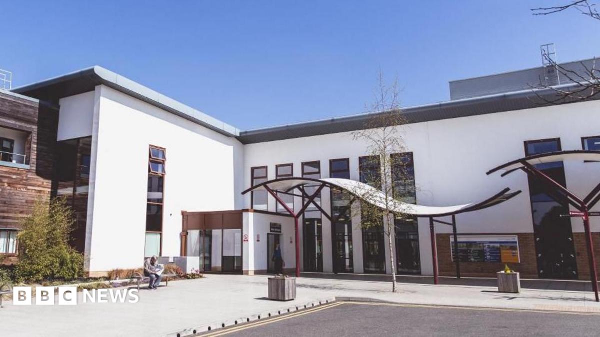 Northamptonshire Healthcare NHS Foundation Trust’s Berrywood Hospital site in Northampton showing a white building with a curved entrance roof