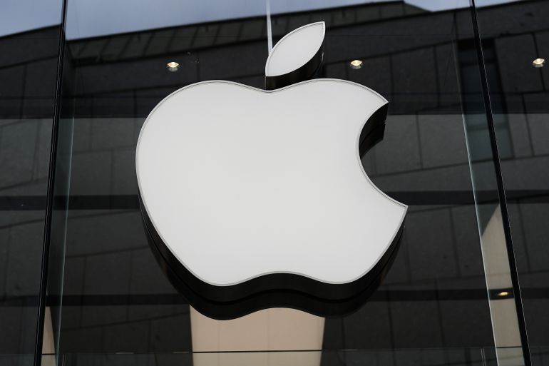 The Apple logo is illuminated at a store in Munich, Germany, on April 2, 2026