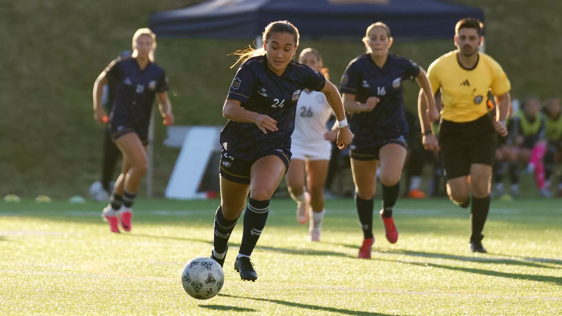 Sienna Gibson dribbles the ball upfield while teammates and defenders trail during a game against the TWU Spartans on Sept. 26, 2026
