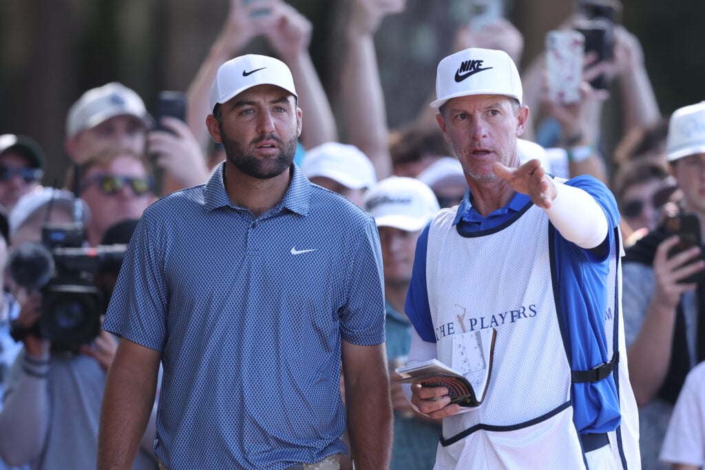 Scottie Scheffler of the United States and caddie Ted Scott prepare to play a shot on the seventh hole during the second round of THE PLAYERS Championship 2026