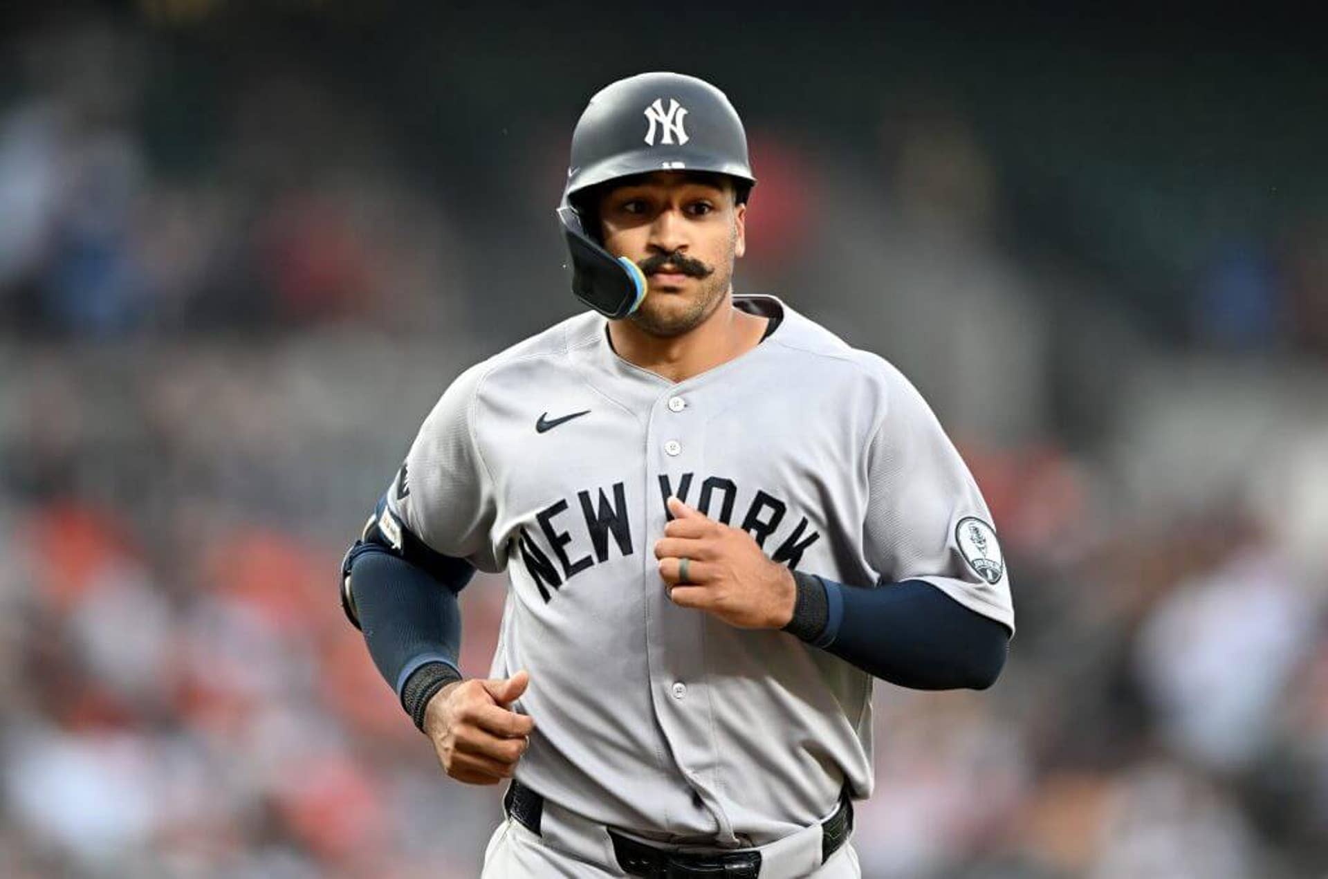 Trent Grisham of the New York Yankees jogs around the bases after a home run.