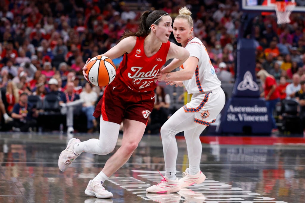 Indiana Fever guard Caitlin Clark (22) drives past Connecticut Sun guard Hailey Van Lith