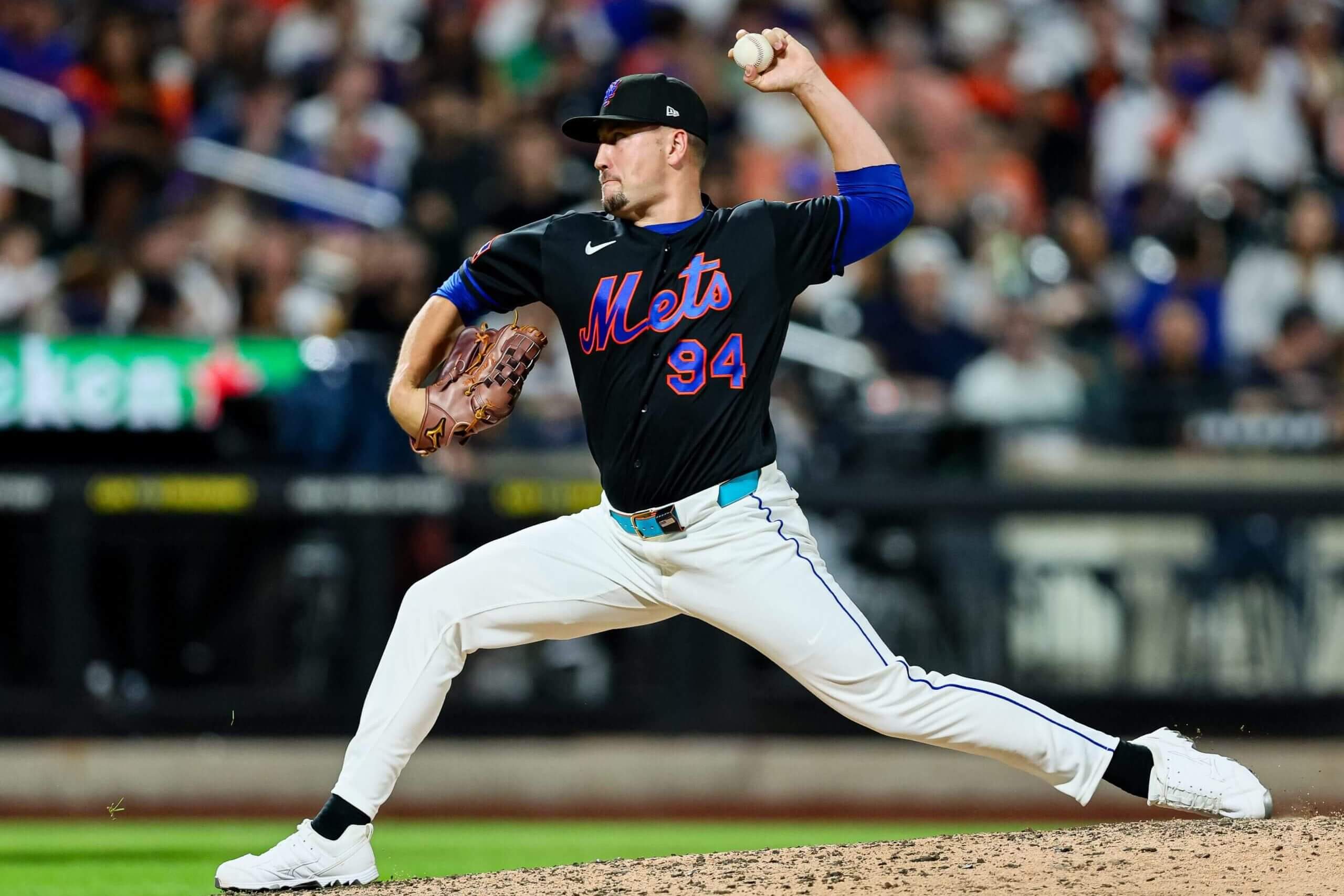 Nate Lavender, with a baseball in his upraised left hand, delivers a pitch for the New York Mets.