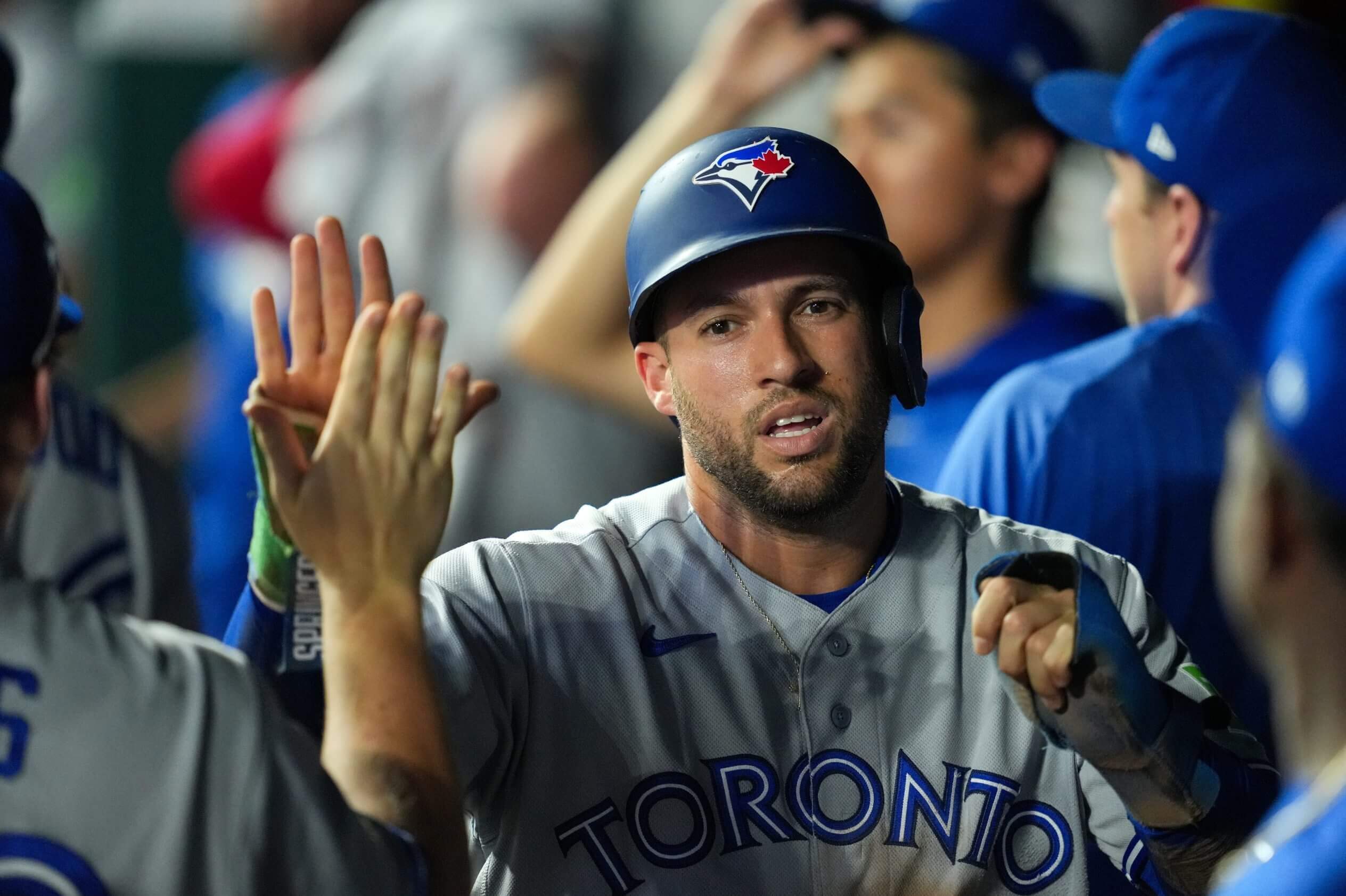 Toronto's George Springer is congratulated in the dugout after scoring a rum against the Kansas City Royals.