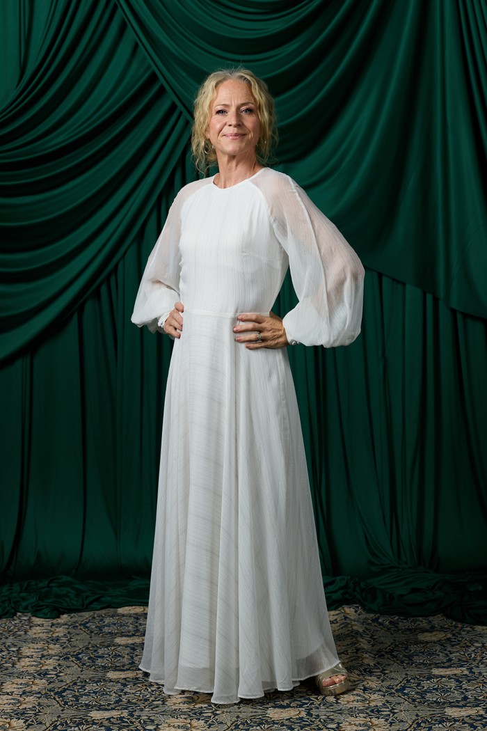 National Television Awards 2026 - Studio Kellie Bright in a white dress with hands on her hips in front of a green curtain at the National Television Awards.