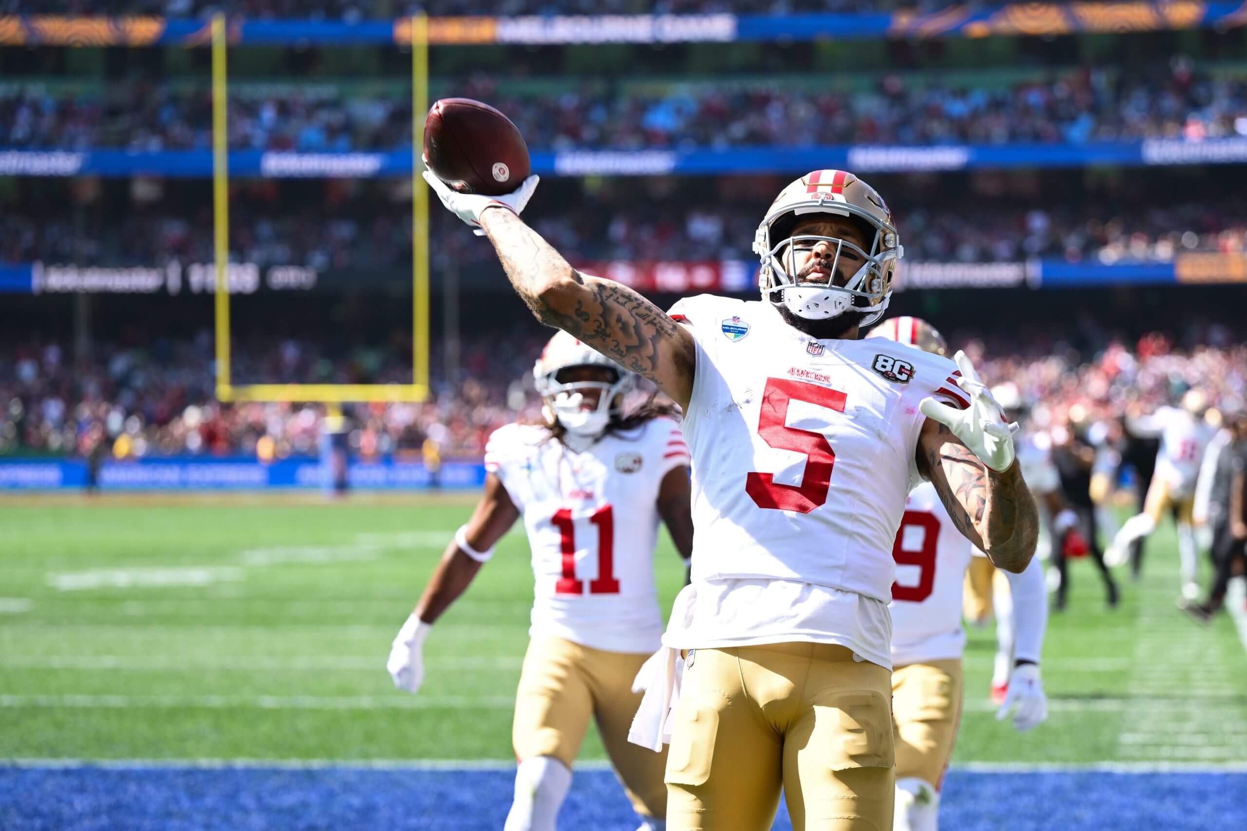 Mike Evans #5 of the San Francisco 49ers celebrates scoring a touchdown in the third quarter of the NFL football game against Los Angeles Rams at the Melbourne Cricket Ground