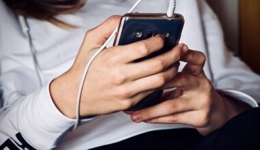A person looks at their cellphone. Their face is not visible.