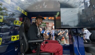 Sixers rookie LaBaron Philon Jr. plays "NBA 2K27" inside a glass gaming truck in front of Geno’s Steaks on Tuesday.