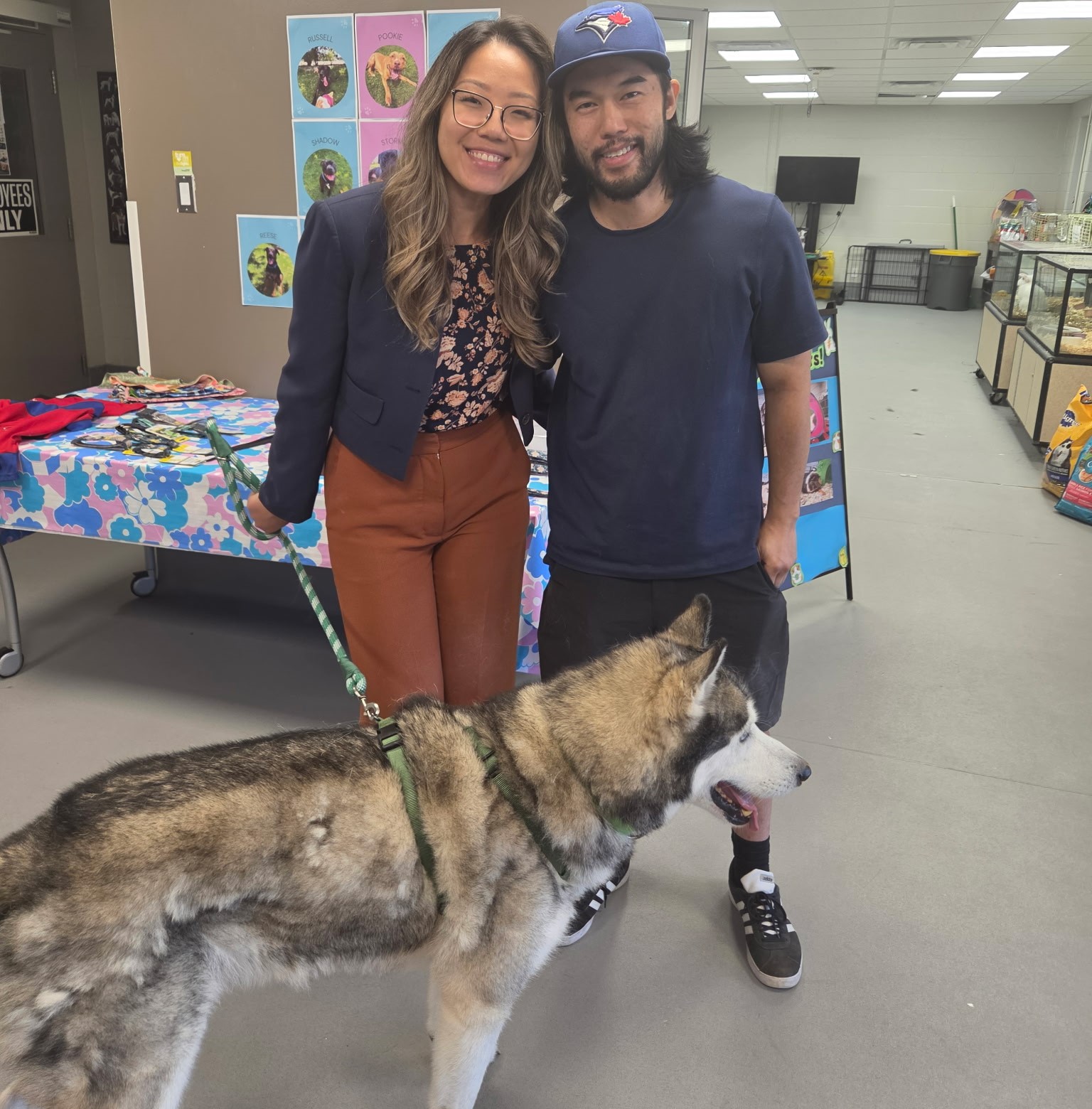 Image of woman smiling next to a dog.