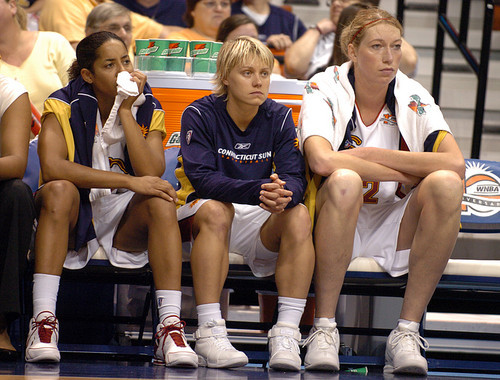 The Sun fell to the Shock again in 2006 during the Eastern Conference finals. From left, Nykesha Sales, Erin Phillips and Margo Dydek watch the final minutes of their season as Detroit closes out the series win. (Courant file photo)