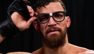 British kickboxer Jonathan Haggerty holds the ONE Championship belt and raises his fist